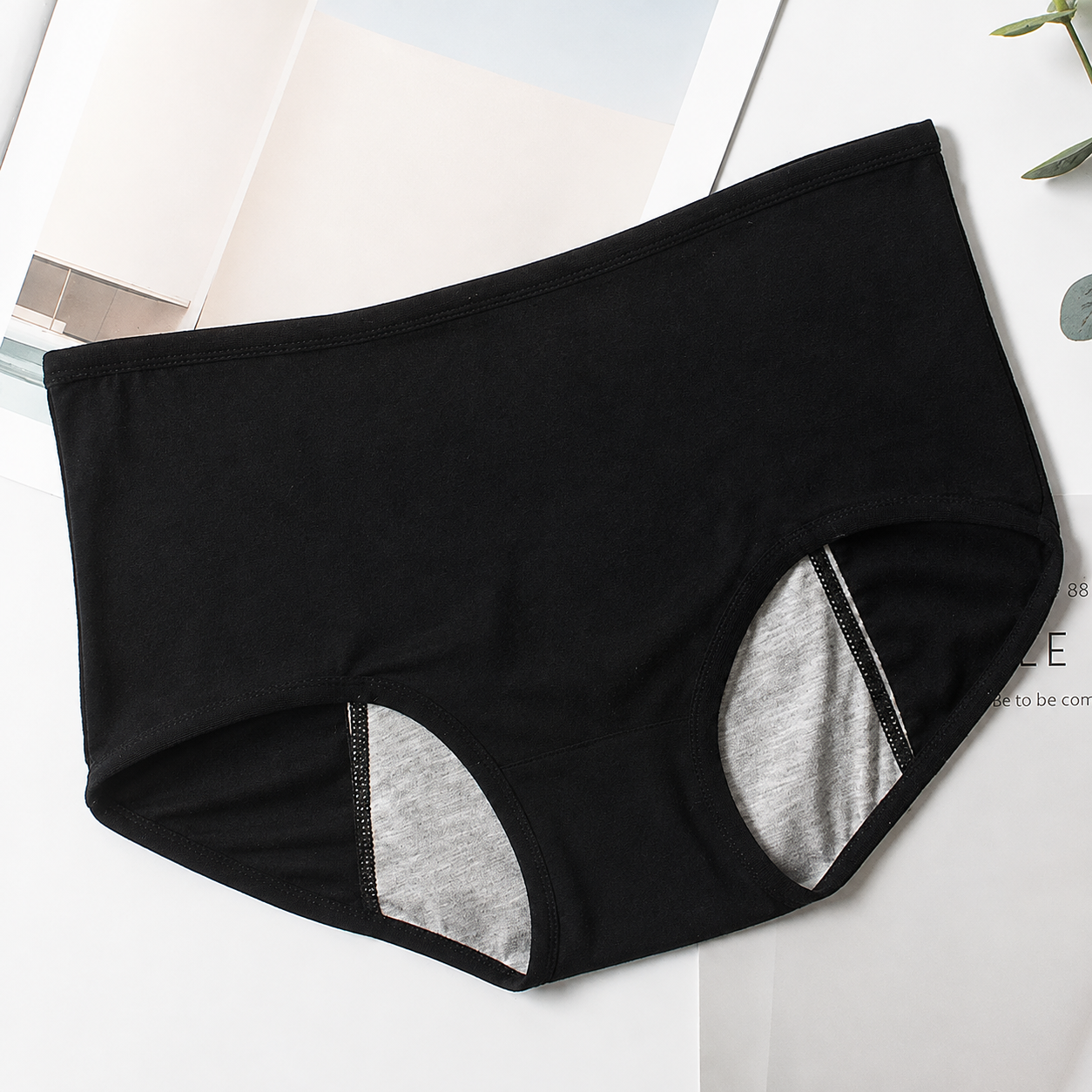 Black leak-proof incontinence underwear for women, flat lay
